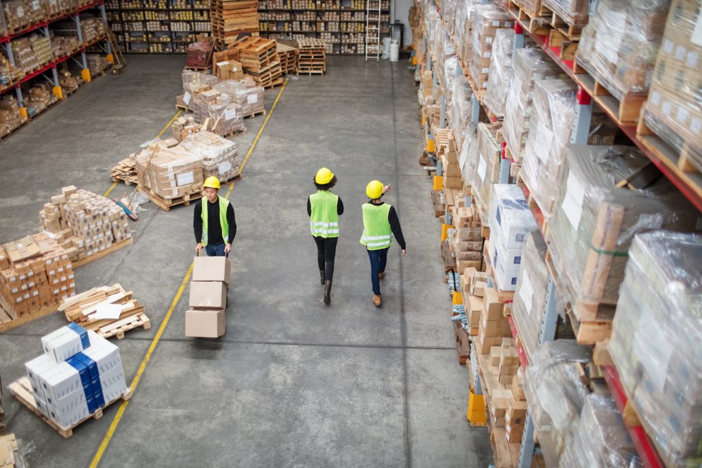 Three workers working in large warehouse, ERP(Enterprise Resource Planning) System in Singapore