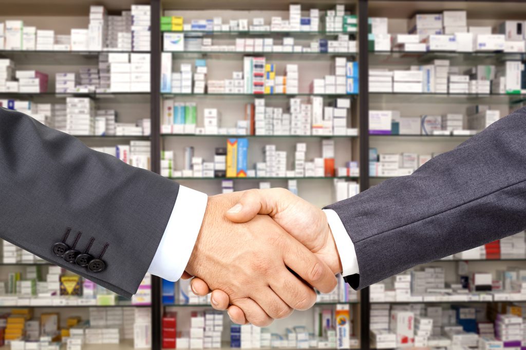 Handshake in the pharmacy backgroundERP(Enterprise Resource Planning) System in Singapore